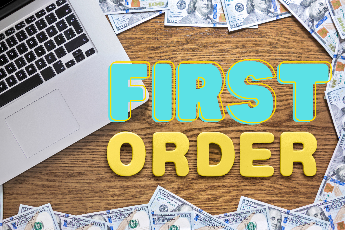 Text reading "FIRST ORDER" with a laptop and scattered money on a wooden surface.