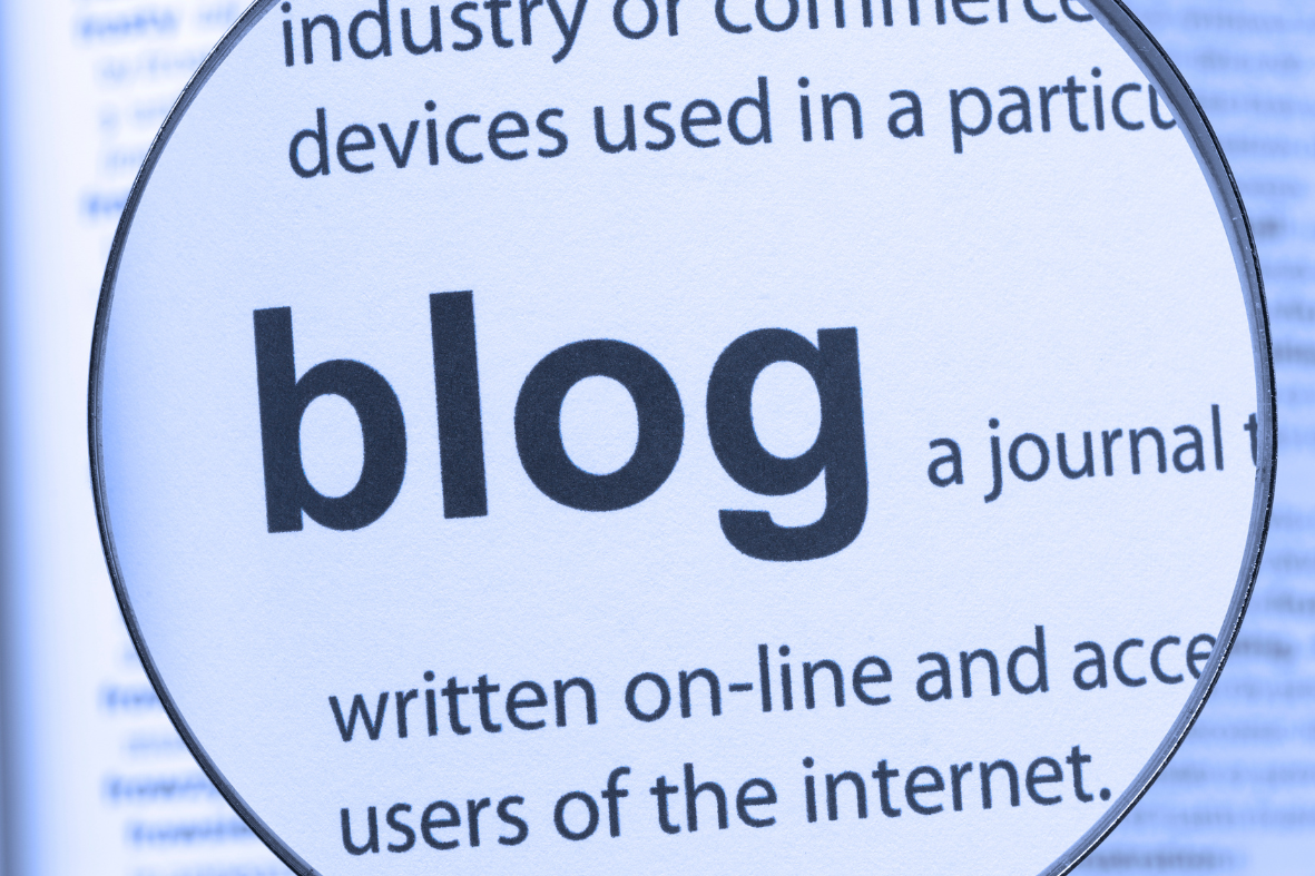 Close-up of the word "blog" in a text, highlighted by a magnifying glass.