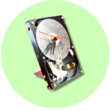 A computer hard drive with a visible spinning disk and electronic components.